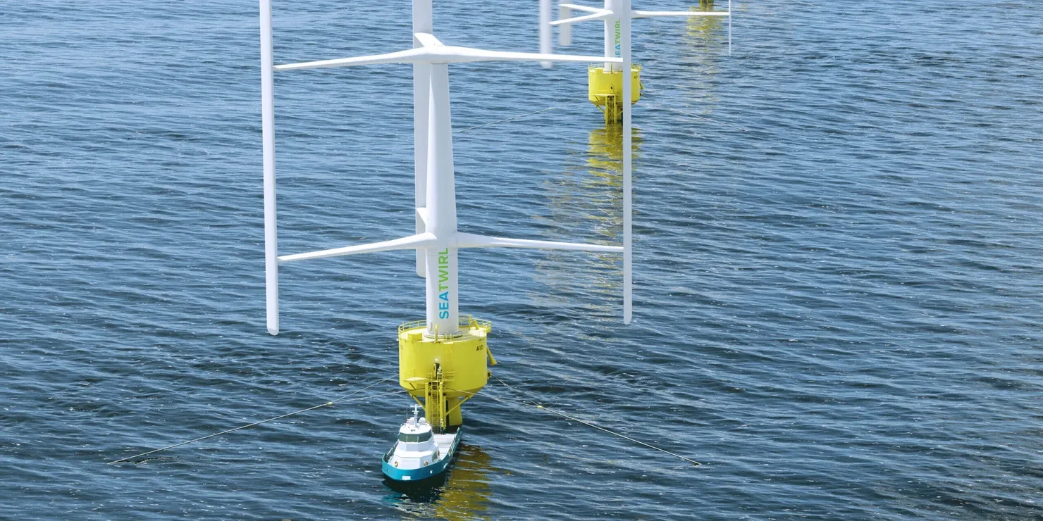 Visualisation of a row of floating vertical-axis wind turbines with yellow floaters, with a small boat by the nearest turbine