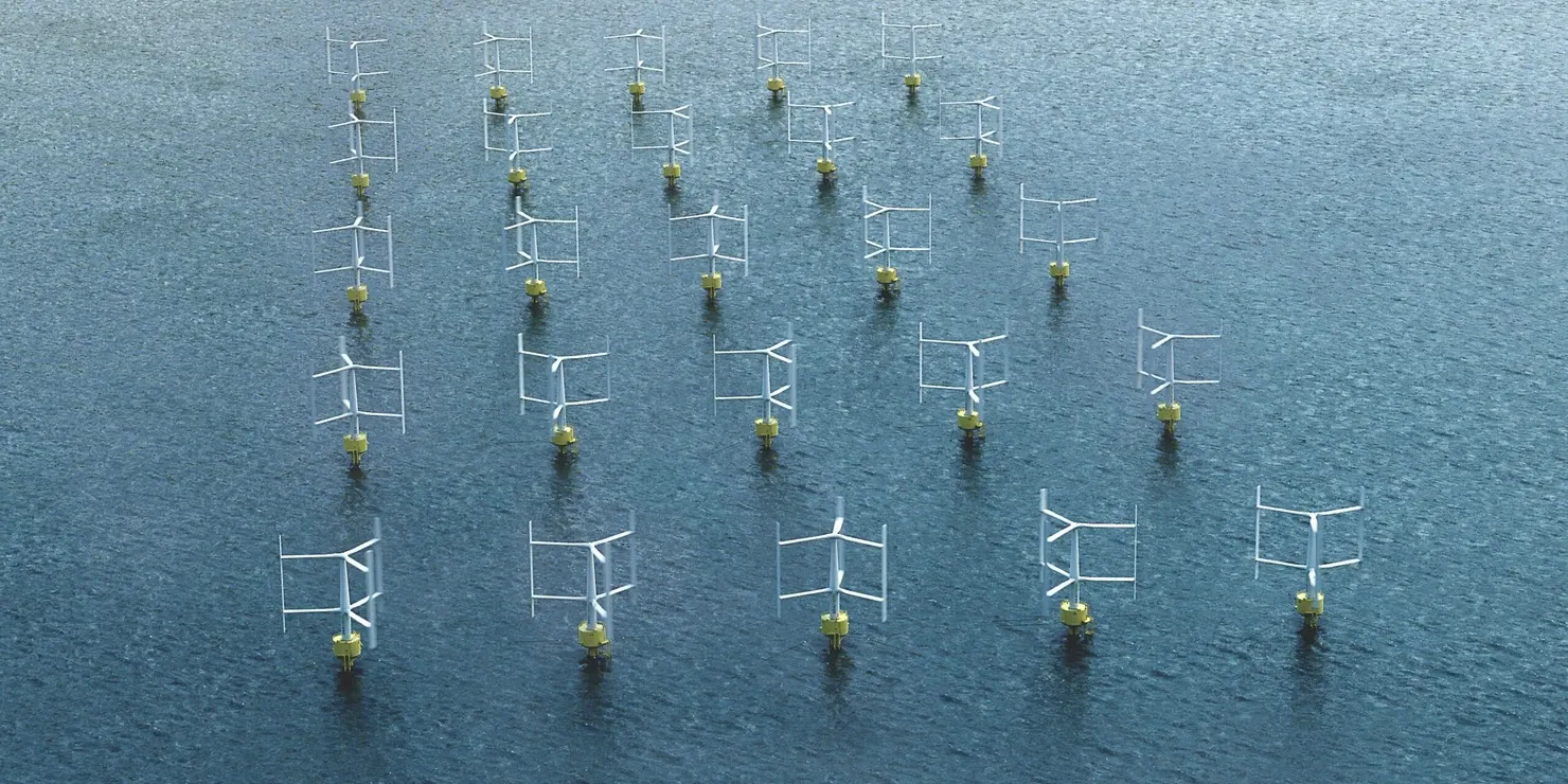 A wind farm with vertical-axis turbines in formation at sea, seen at an angle from above
